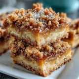 Golden crumb topping covers a bright yellow lemon layer in these delicious Homemade Lemon Crumb Bars.