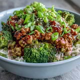 Steamed broccoli florets and saucy turkey mingle in a savory honey-sriracha glaze over nutty grains.