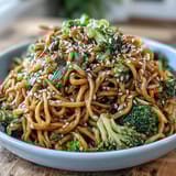 Fresh green onions and toasted sesame seeds garnish this vibrant Asian Teriyaki Noodle Bowl.