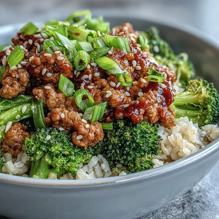 Freshly chopped green onions sprinkle atop the dairy-free bowl, served with steamed broccoli and rice.