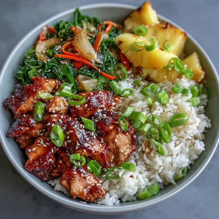 Overhead view of a Teriyaki Chicken and Rice Bowl featuring tender chicken, crisp vegetables, and toasted sesame seeds.