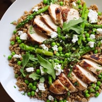 Warm Spring Farro Chicken Salad with tender grains, juicy chicken, crisp asparagus, and peas tossed in lemon vinaigrette.