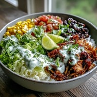 Slow-cooked, crispy-edged Carnitas Burrito Bowl topped with zesty salsa and fresh cilantro.