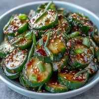Crisp Asian cucumber salad with sesame and rice vinegar dressing, perfect for a light vegan appetizer or side dish.